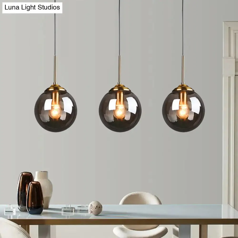 Sleek Brass Pendant Lamp with Amber/Smoke Glass Shade – Perfect for Dining Room Ceilings