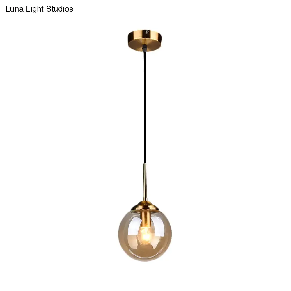 Sleek Brass Pendant Lamp with Amber/Smoke Glass Shade – Perfect for Dining Room Ceilings