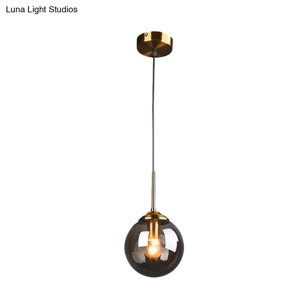 Sleek Brass Pendant Lamp with Amber/Smoke Glass Shade – Perfect for Dining Room Ceilings