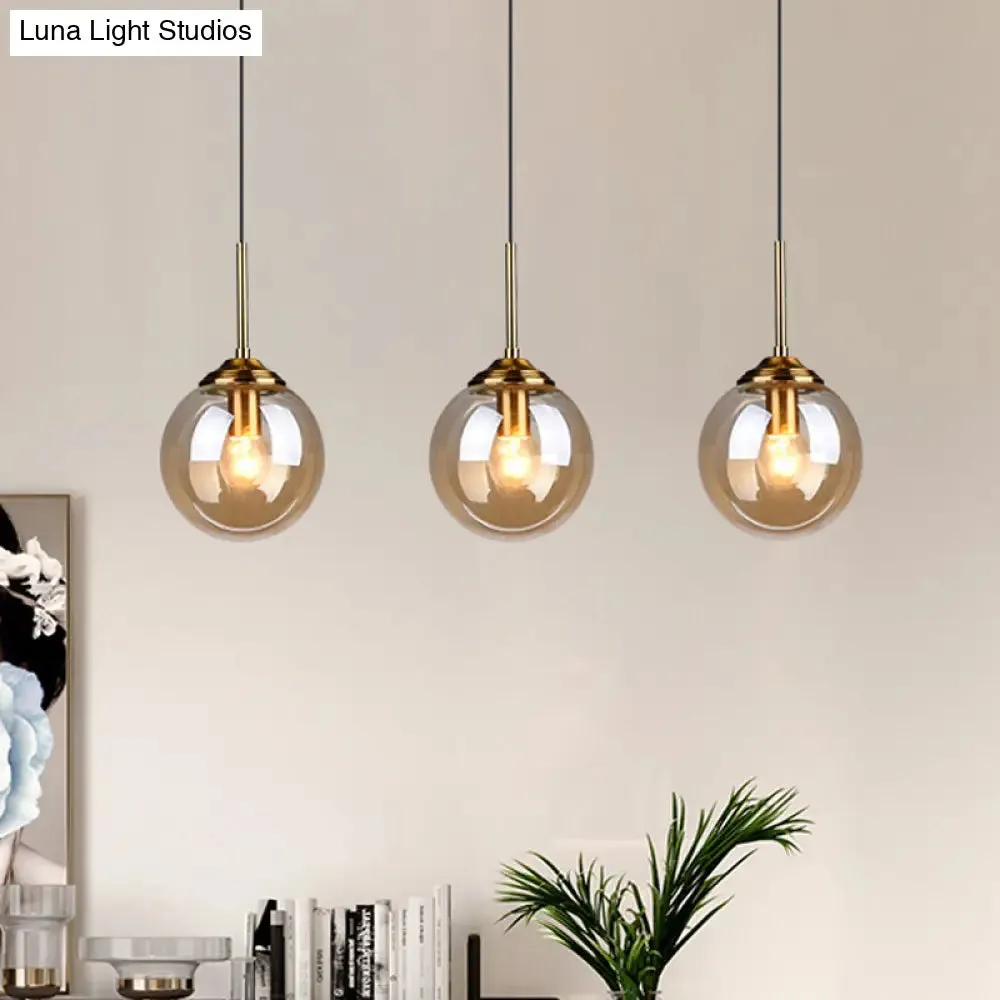 Sleek Brass Pendant Lamp with Amber/Smoke Glass Shade – Perfect for Dining Room Ceilings