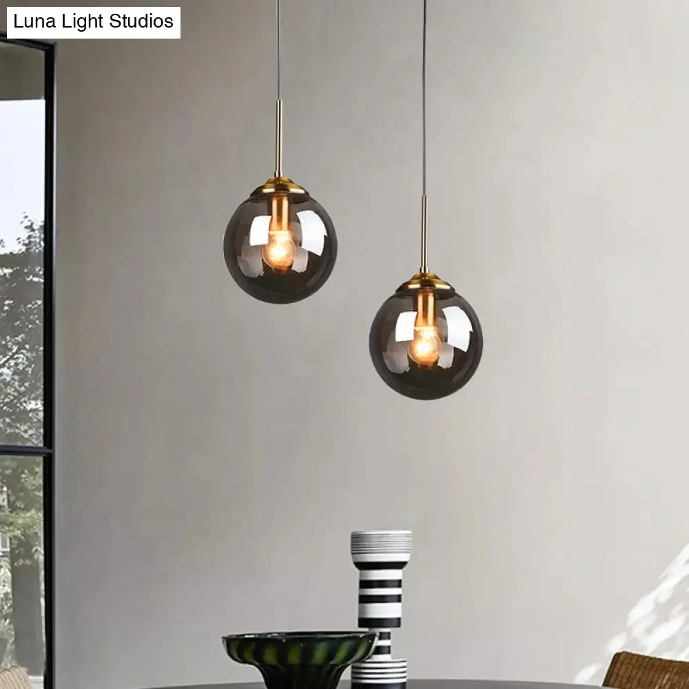 Sleek Brass Pendant Lamp with Amber/Smoke Glass Shade – Perfect for Dining Room Ceilings